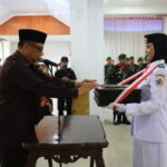 Pj Wali Kota Abdullah Mokoginta Pimpin Upacara Pemindahan Duplikat Bendera Merah Putih